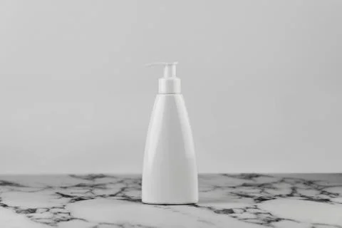 Blank empty moisturizer container on white background on marble table. Cosmet Stock Photos