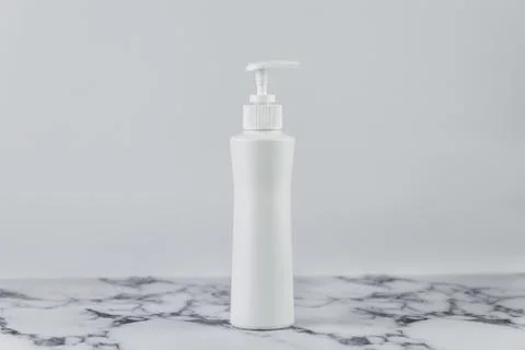 Blank empty moisturizer container on white background on marble table. Cosmet Stock Photos
