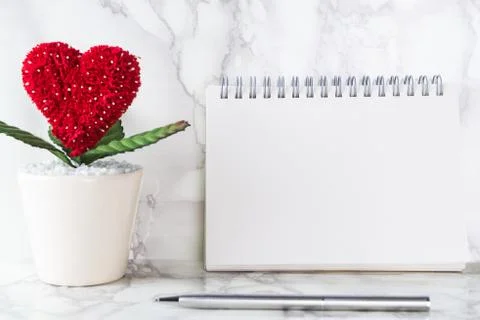 Blank empty notebook page with heart flower pot for love story concept 库存照片