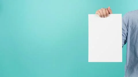 Blank empty paper in man hand and wear blue shirt on mint or Tiffany Blue bac Stock Photos