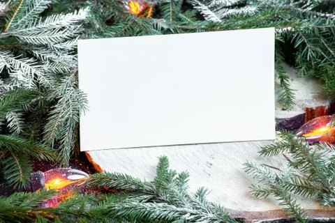 Blank envelope on christmas tree branches, new year decoration and garland. Stock Photos