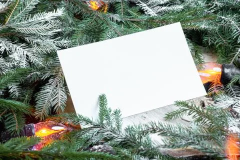 Blank envelope on christmas tree branches, new year decoration and garland. Stock Photos