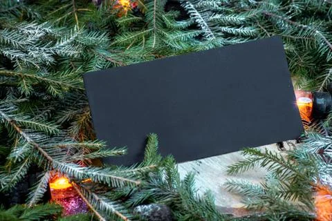 Blank envelope on christmas tree branches, new year decoration and garland. Stock Photos