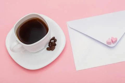 Blank envelope isolated and White cup full of coffee with roasted coffee beans Stock Photos