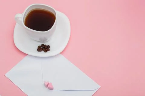 Blank envelope isolated and White cup full of coffee with roasted coffee beans Stock Photos