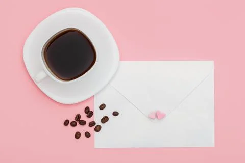 Blank envelope isolated and White cup full of coffee with roasted coffee beans Stock Photos