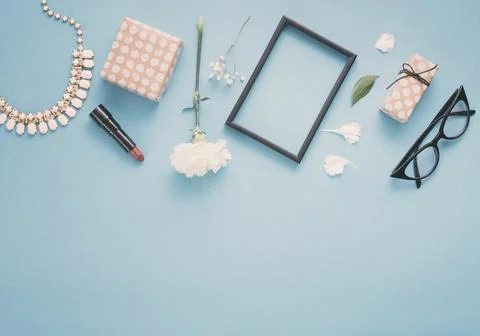 Blank frame with flowers gift boxes lipstick table. High quality photo Stock Photos