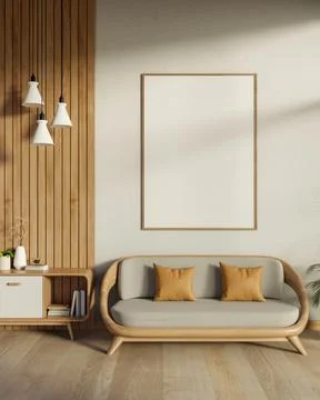 Blank frame hanging on white wall over wooden sofa on parquet floor in sunl.. Ilustración de archivo