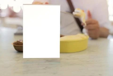 Blank frame on marble table with man and some sweets in restaurant setting .. Stock Photos