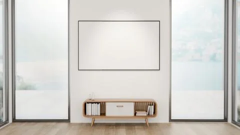 Blank frame over a table between two glass doors of a wooden floor room wit.. Ilustração Stock