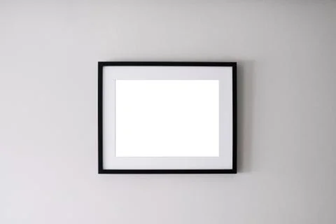 Blank frame on a white wall background 写真素材