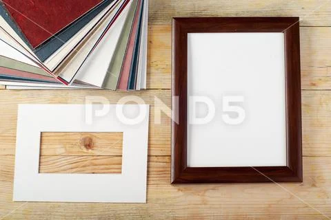 Blank frame on wooden background with sawdust Stock Photos