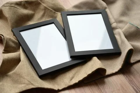 Blank frames lying on the floor. Mockup for two photos or pictures. Stock Photos
