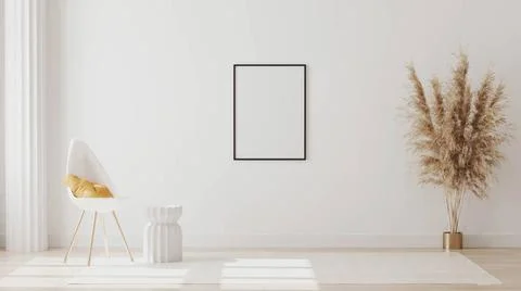 Blank frames on white wall in empty room with column and white chair with ... Foto stock