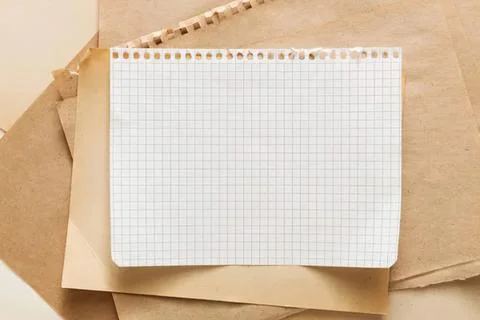 Blank graph paper on brown background for notes or sketches Stock Photos