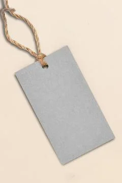 Blank gray tag with jute string on light background Stock Photos