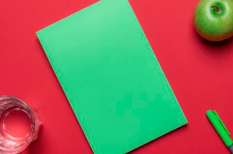 Blank green notepad on a red background. Diet concept. Above view. Stock Photos