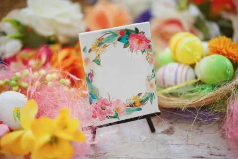 Blank greeting among the Easter eggs Joyful colorful spring background Stock Photos