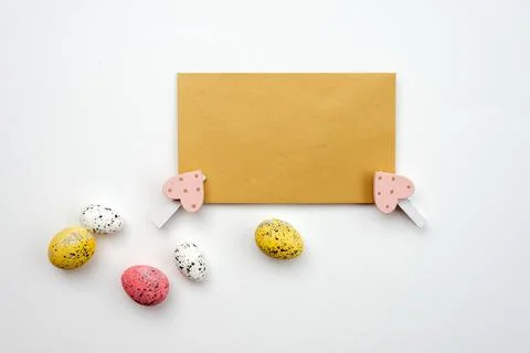 Blank greeting card and easter eggs on a white background. Stock Photos