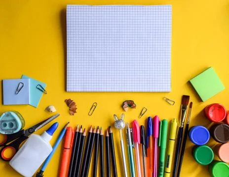 Blank Grid Notebook with Colorful School Supplies Along Bottom Stock Photos