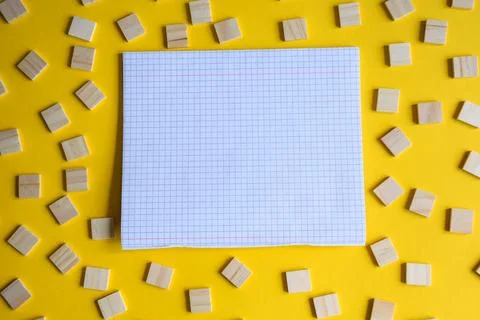 Blank Grid Notebook Page Surrounded by Scattered Wooden Blocks Stock Photos