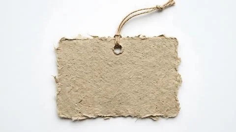 Blank handmade paper tag with rustic twine string for product labeling and .. Stock Photos