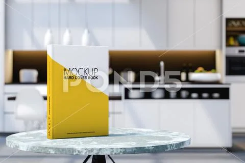 Blank hardcover book standing on a table in a kitchen. Book mockup PSD-Vorlage