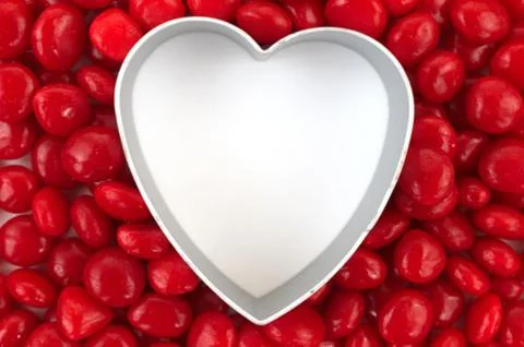 Blank heart surrounded with red candy Stock Photos