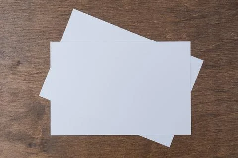 Blank horizontal postcard mockup placed on wooden table surface. Clean card.. Stock Photos