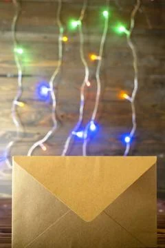 Blank kraft paper envelope on dark wooden background decorated with colorfu.. Stock Photos