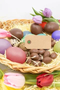 Blank label, painted easter eggs and chocolate eggs with tulips graphic resource Stock Photos