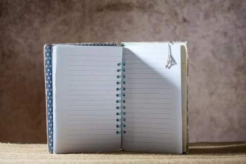 Blank lined notebook on a creative brown blurred background Stock Photos