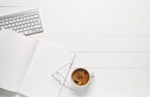 Blank magazine with cup of coffee, computer keyboard and eyeglasses on wooden Stock Photos