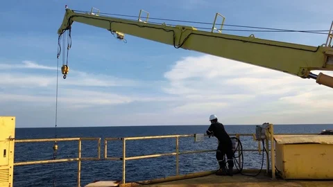 Blank man or man watch offshore crane aux hoist with clear blue sky in logist Stock Footage 118486406