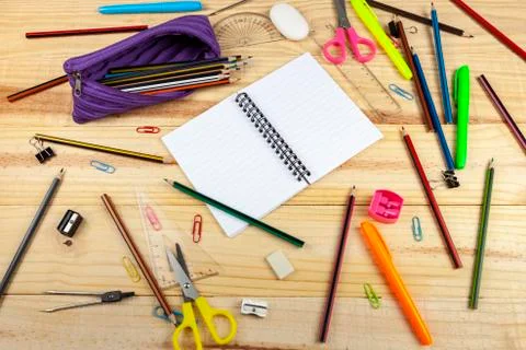 Blank note book pages on a messy wooden school desk Stock Photos