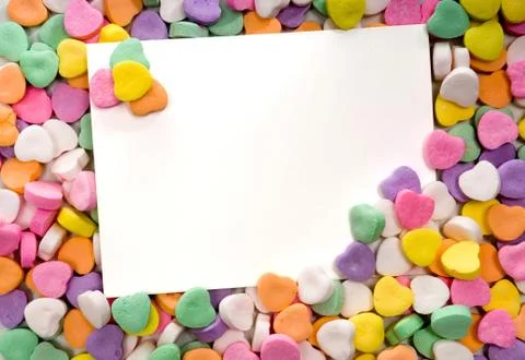 Blank note card surrounded, framed by candy hearts Stock Photos