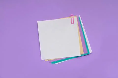 Blank note papers label with clip on violet background Stock Photos