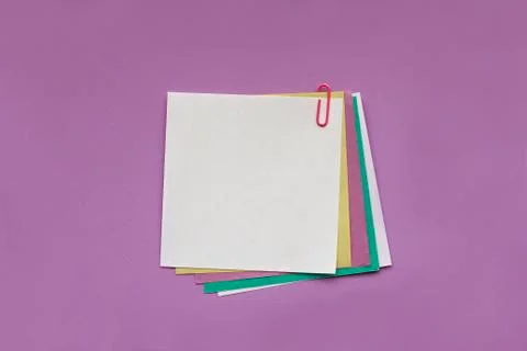 Blank note papers label with clip on purple background Stock Photos