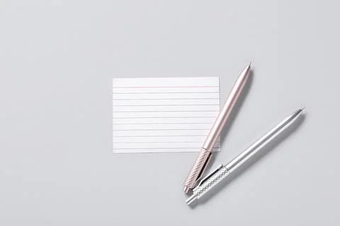 Blank note with pens on grey background Stock Photos