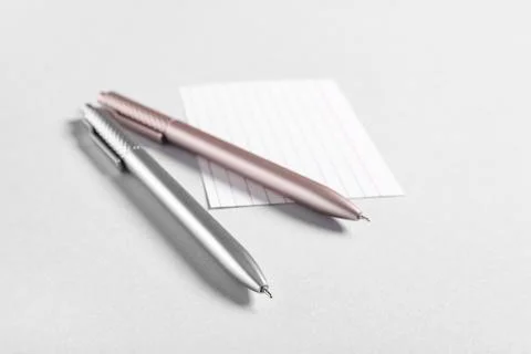 Blank note with pens on grey background Stock Photos