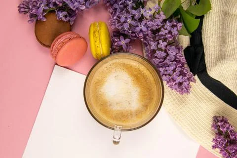 Blank note sheet surrounded by lilac colors, colorful macaroons and a beach h Stock Photos