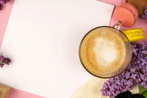 Blank note sheet surrounded by lilac colors and colorful macaroons. Stylish m Stock Photos