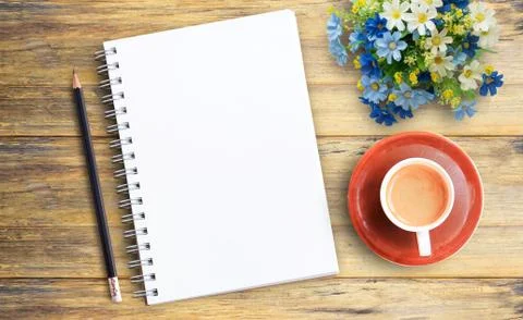 Blank notebook and cup of coffee on wooden table Foto stock