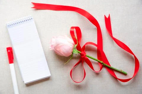 Blank notebook and a rose with red ribbon Stock Photos