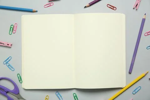 Blank notebook and stationery on light grey background, flat lay. Space for.. Stock Photos