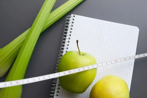 Blank notebook with apple and celery Stock Photos