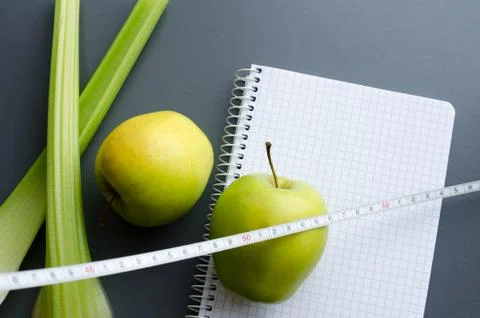 Blank notebook with apple and celery Stock Photos