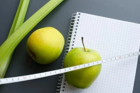 Blank notebook with apple and celery Foto stock