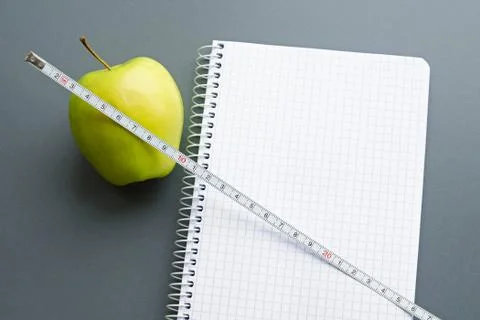 Blank notebook with apple and measuring tape Stock Photos