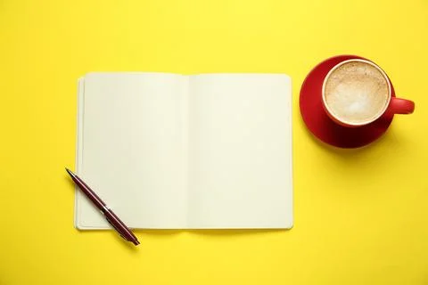 Blank notebook, coffee and pen on yellow background, flat lay. Space for text Stock Photos